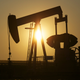 An oil pump jack pumps oil in a field near Calgary, Alberta, July 21, 2014.